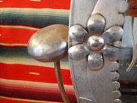 Mexican vintage tin art, a wonderfully stamped tin-work mirror, c. 1945. The mirror swivels up and down. It is extremely beautiful and very well-done! Closeup photo of tin-work mirror.
