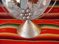 Mexican vintage tin art, a wonderfully stamped tin-work mirror, c. 1945. The mirror swivels up and down. It is extremely beautiful and very well-done! A second closeup photo of the base.