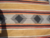 Native American Indian vintage textiles, and Navajo vintage rugs and textiles, a wonderful Navajo banded rug beautifully woven of natural-colored wool, Arizona or New Mexico, c. 1940. Closeup photo of a part of the rug, showing the fine weave.