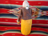 Navajo wood carving of elderly woman, view of back.