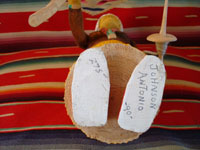Photo of signature on bottom of carving of elderly Navajo woman.