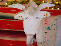 Closeup photo of head of goat by Navajo folk artist Mami Deschillie.