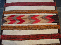 Closeup photo of center of Navajo textile with hearts.