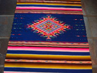 Mexican Saltillo sarape with blue background c. 1910, closeup of center diamond