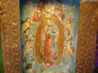 Closeup of Mexican tinwork nicho with Our Lady of Guadalupe
