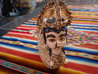 Front closeup of pottery mermaid, showing "beauty mark" on her face.