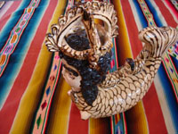 Side view of Mexican pottery mermaid with beauty mark.