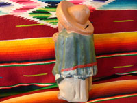 Side view of Tonala bank, showing slot for coins on man's back