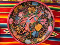 Mexican vintage woodcarving, batea with stylized bird, Uruapan, Michoacan, c. 1920.
