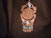 Closeup photo of Mexican coin earrings.