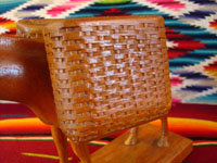 Closeup photo of wood burro, showing details of the basket.