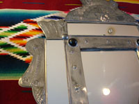 Closeup of Mexican tinwork mirror, showing fine stamping.