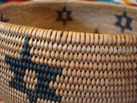 Native American Indian basket, Washo basket with stars, closeup photo.