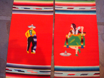 Mexican vintage textiles and Saltillo sarapes, a wonderful pair of matching Saltillo sarapes featuring a dashing Mexican charro (horseman) and a lovely China Poblana or charra dancing around a sombrero, c. 1940's. They are both finely woven of soft wool, and the colors are vibrant. Closeup of the pair.