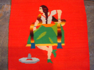 Mexican vintage textiles and Saltillo sarapes, a wonderful pair of matching Saltillo sarapes featuring a dashing Mexican charro (horseman) and a lovely China Poblana or charra dancing around a sombrero, c. 1940's. They are both finely woven of soft wool, and the colors are vibrant. Closeup photo of the China Poblana or charra, doing the famous Mexican hat-dance.
