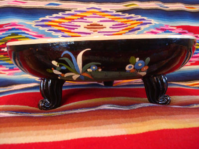 Mexican vintage pottery and ceramics, a black-ware bowl with a tri-pod base, Tlaquepaque, Jalisco, c. 1930's. The bowl has a very graceful and beautiful form, and the artwork on the bowl is very sharp and intricate. The central design is a wonderful celebration of Mexican rural life.