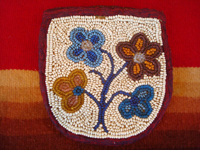 Native American Indian beadwork, a beautiful beaded pouch on native-tanned hide, Woodlands Indian, c. 1910-20.