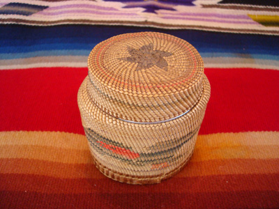 Native American Indian antique basket, a finely woven Northwest Coast basket, woven around a Pond's Cold Cream Jar and lid, Nootka or Makah Indians, c. 1920's. The weaving features wonderful eagles on two sides of the jar.
