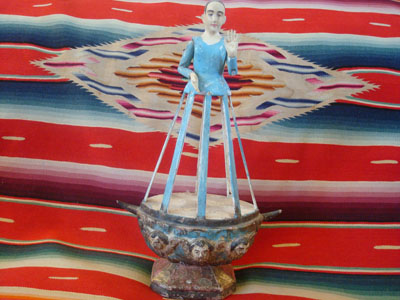 Mexican vintage devotional art, a wood-carving of the Madonna, with glass eyes and angels supporting her on the carved wooden base, c. 1900.