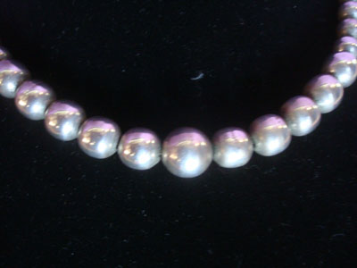 Native American Indian sterling silver jewelry, and Navajo vintage sterling silver jewelry, a beautiful necklace with a single strant of silbver beads, Arizona or New Mexico, c. 1950's. The necklace is very graceful and elegant. Closeup photo of a part of the Navajo necklace.