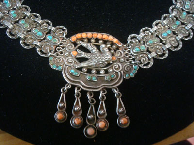 Mexican vintage sterling silver jewelry, and Taxco vintage sterling silver jewelry, a stunning Matl sterling silver necklace, signed Matl, Taxco, c. 1940. The spectacular necklace is embellished with turquoise and coral gems. A closeup photo of a part of the necklace.